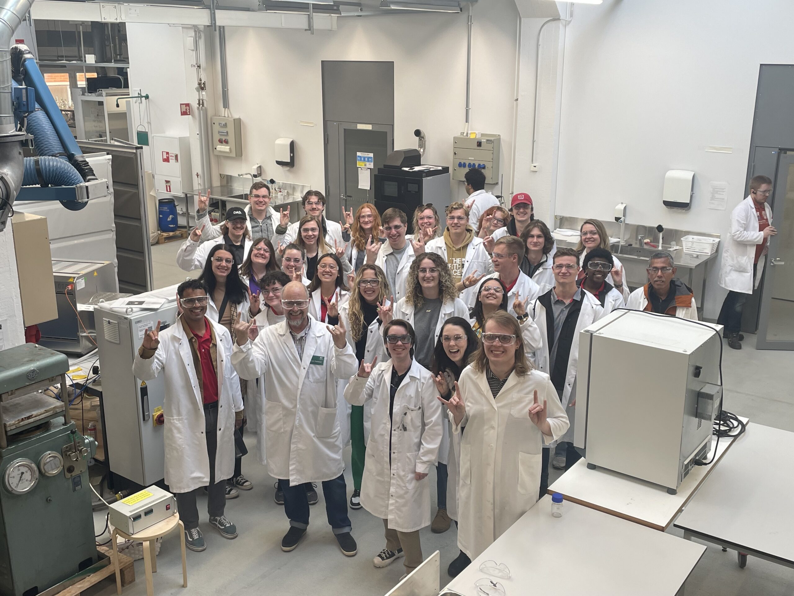 Students put up the wolfy sign in the lab - Day 2 - Aalto University and Valmet Jarvenpaa Pilot Plant - Paper Science and Engineering Study Abroad